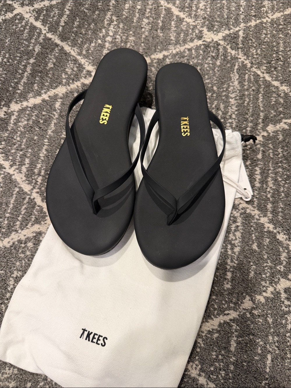 TKEES Black Simple Strap Flip Flops with Gold Logo